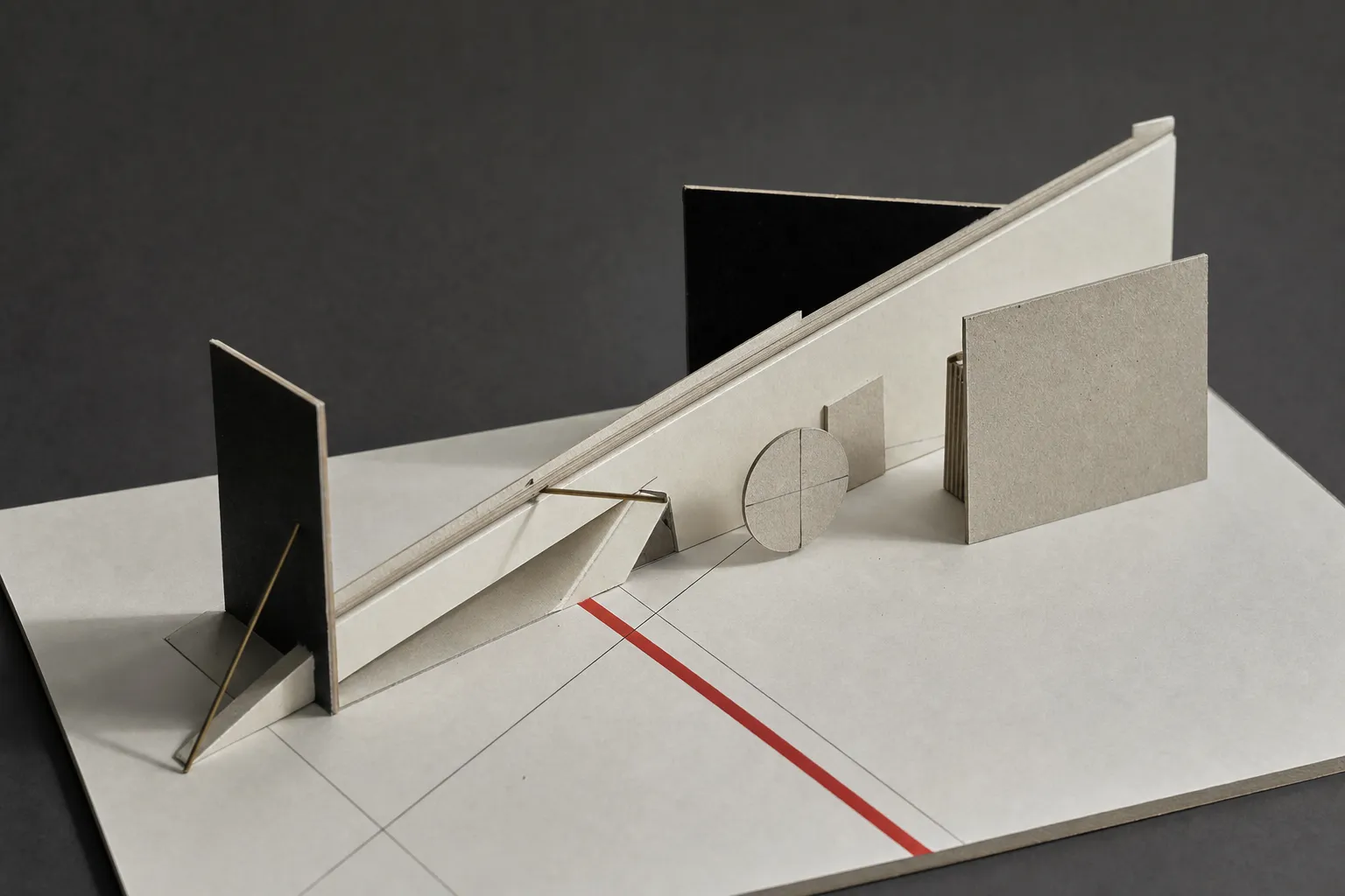 A minimalist constructivist study model with folded manuscript paper sheets, precise drafting rules, and a single red diagonal accent line