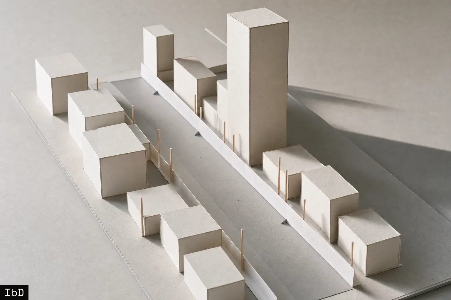 Architectural study model showing short and tall card building blocks set back equally from a central street strip along a marked setback guide.