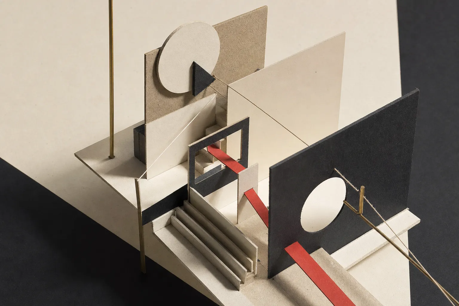 Constructivist architectural study model of intersecting card planes and decision paths with a red accent line.