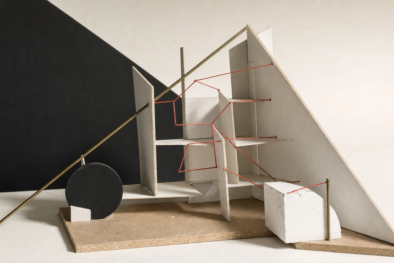 Abstract constructivist study model with interlocking cardboard planes, plaster masses, and a red linear thread representing alternative decision pathways.